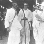 Read more about the article Gandhi in discussion with co-workers at Maritzburg Railway Station, South Africa, December 1913